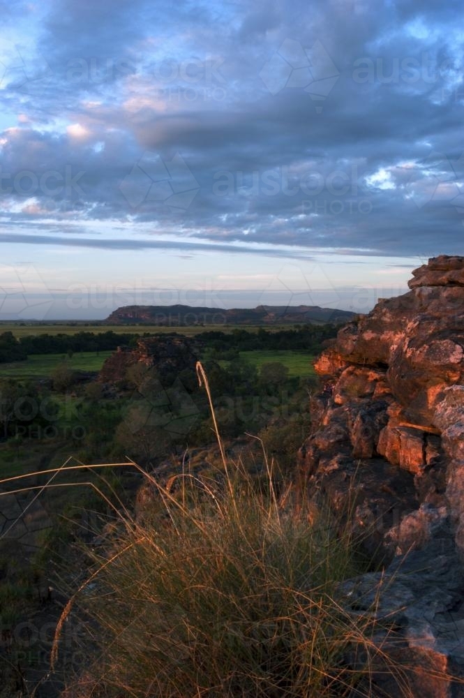Ubirr Rock Kakadu at sunset with dark clouds - Australian Stock Image