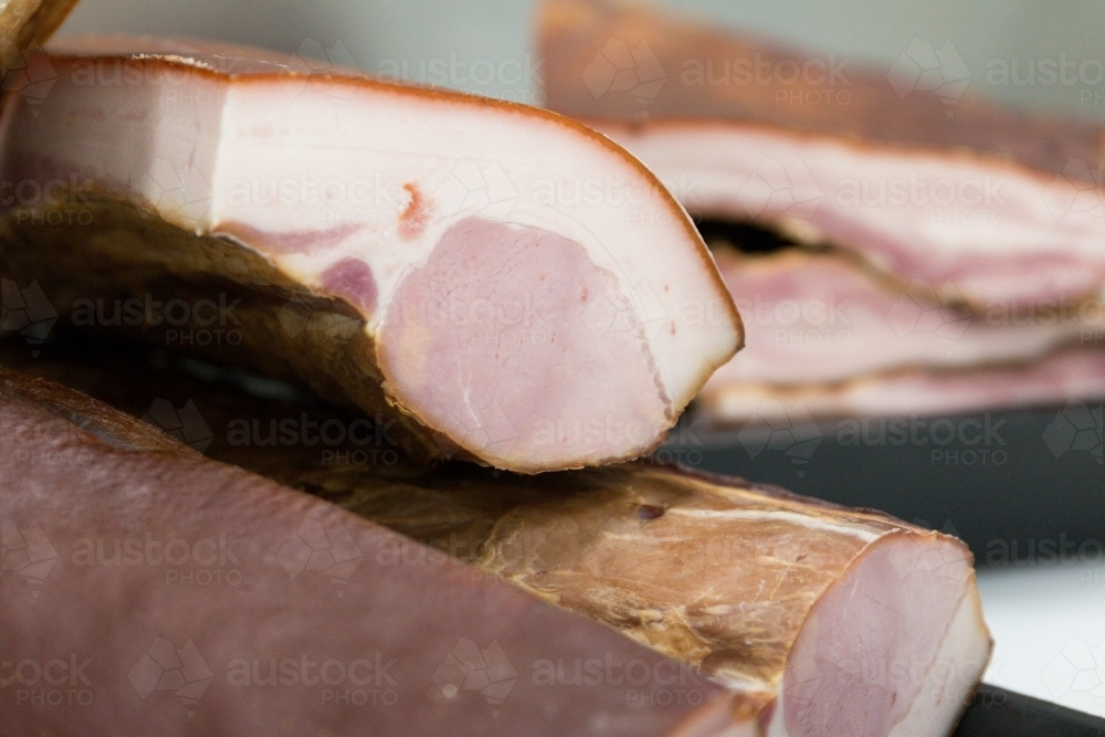 Uncut pork on trays in butcher shop - Australian Stock Image