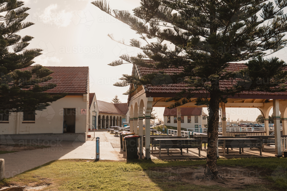 Undercover picnic tables at the Pavillion at Nobbys Beach in Newcastle - Australian Stock Image