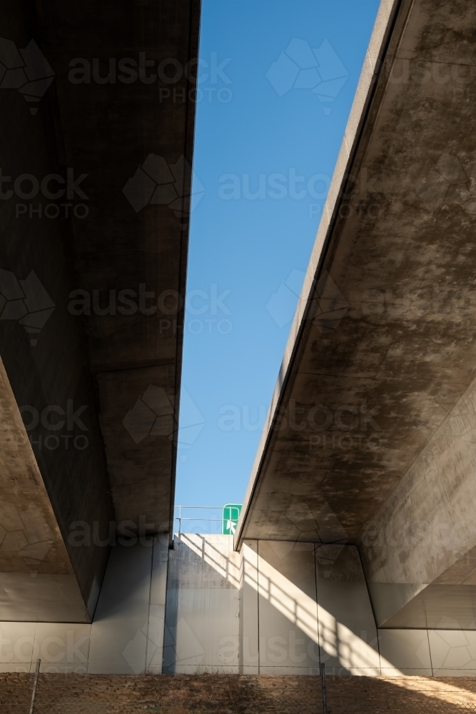 Underside of concrete bridge creating shadows - Australian Stock Image