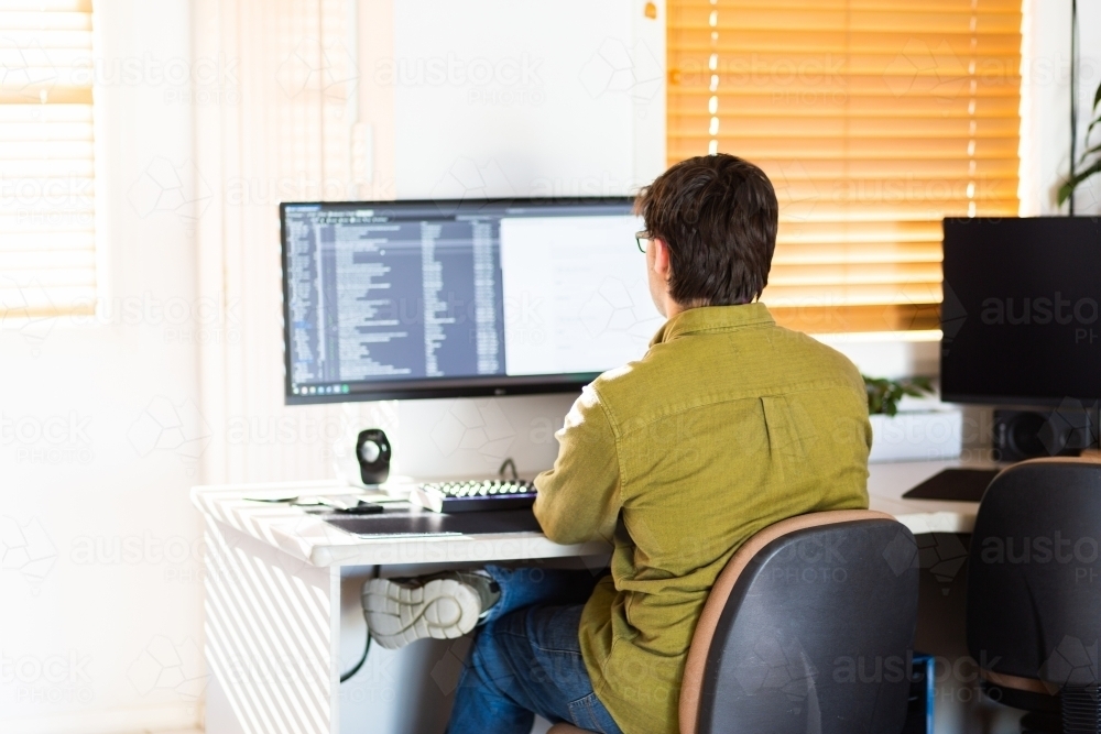 Image of Uni Student doing assignments from computer at home during ...