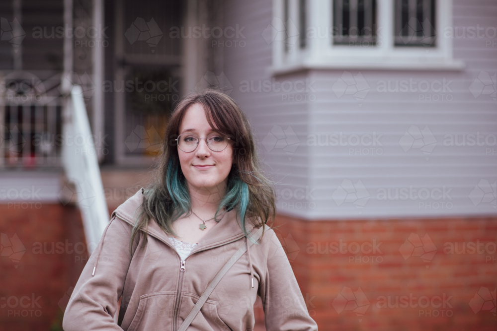 University Student with Dyed Hair in Front of Residential Building - Australian Stock Image