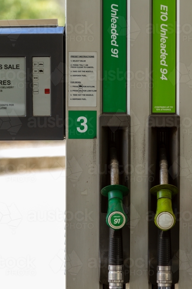 Unleaded 91 and E10 fuel nozzles at petrol pump bowser. - Australian Stock Image