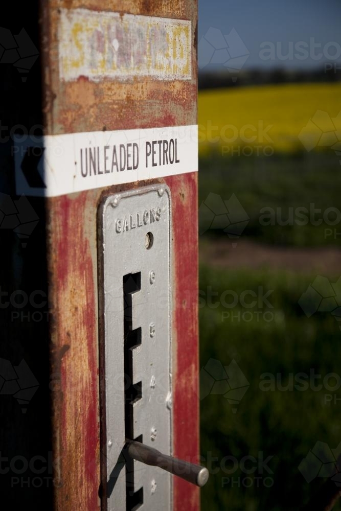 Unleaded petrol sign on vintage petrol bowser found on a farm - Australian Stock Image