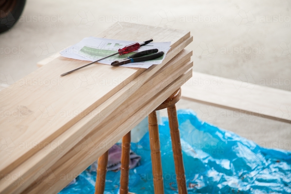 Unstained timber with building plans and tools - Australian Stock Image