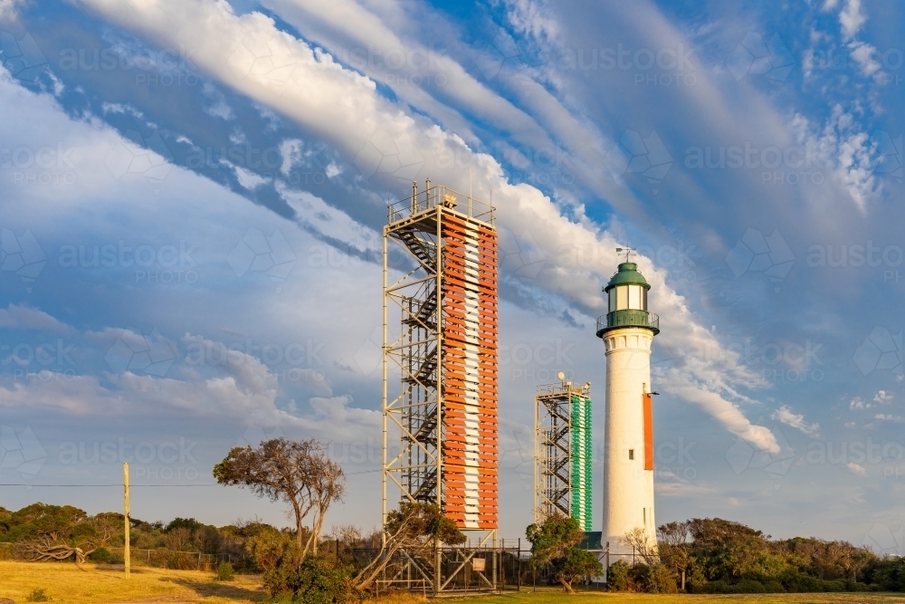 Unusual cloud formation over a tall lighthouse - Australian Stock Image
