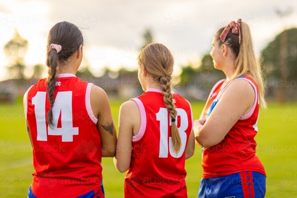 upper bodies of three female football players from behind - Australian Stock Image