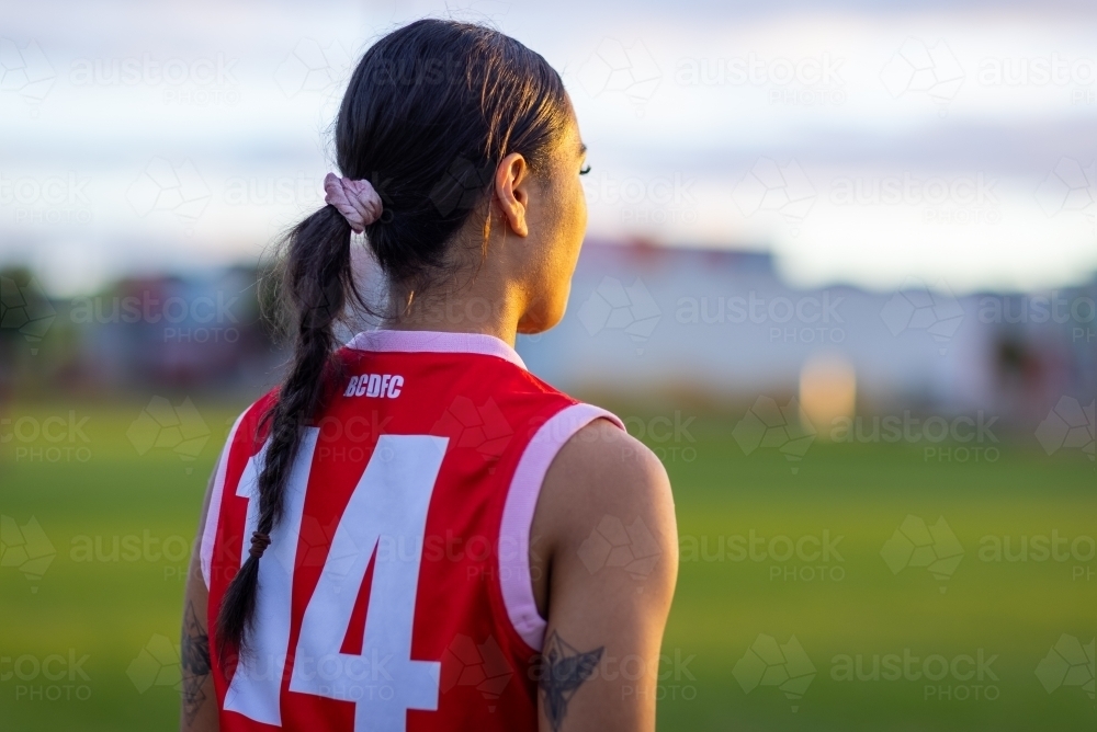 upper body of female football player seen from behind - Australian Stock Image