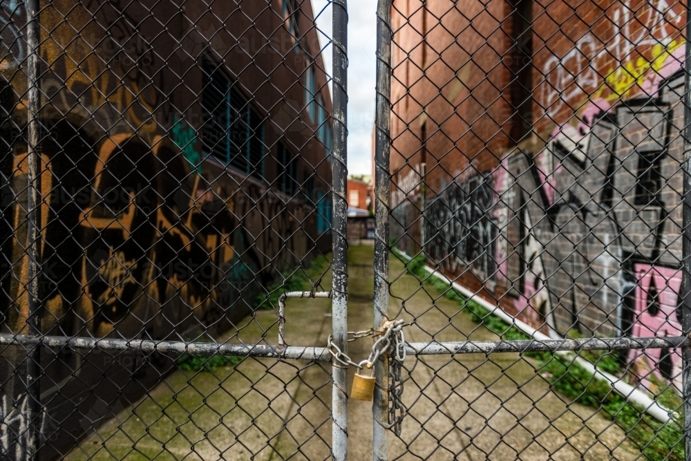 urban street scene, locked gate with chain and padlock - Australian Stock Image