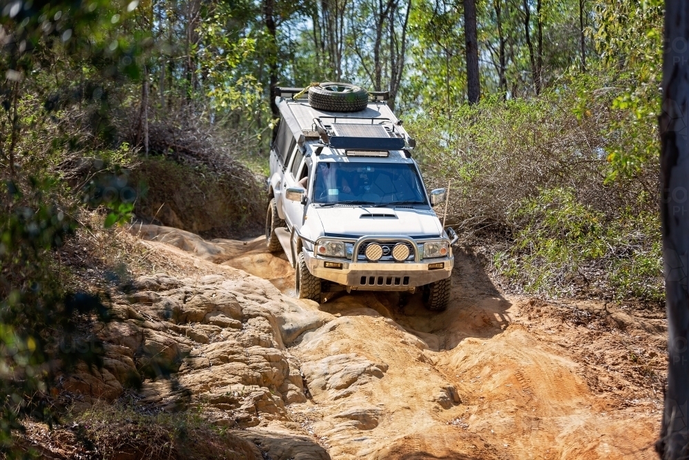 Ute 4 wheel driving down steep rocky hillside - Australian Stock Image