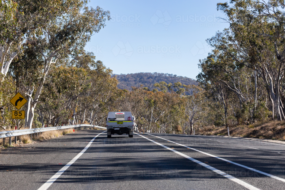 Image of ute driving along tree lined rural highway in NSW Australia ...
