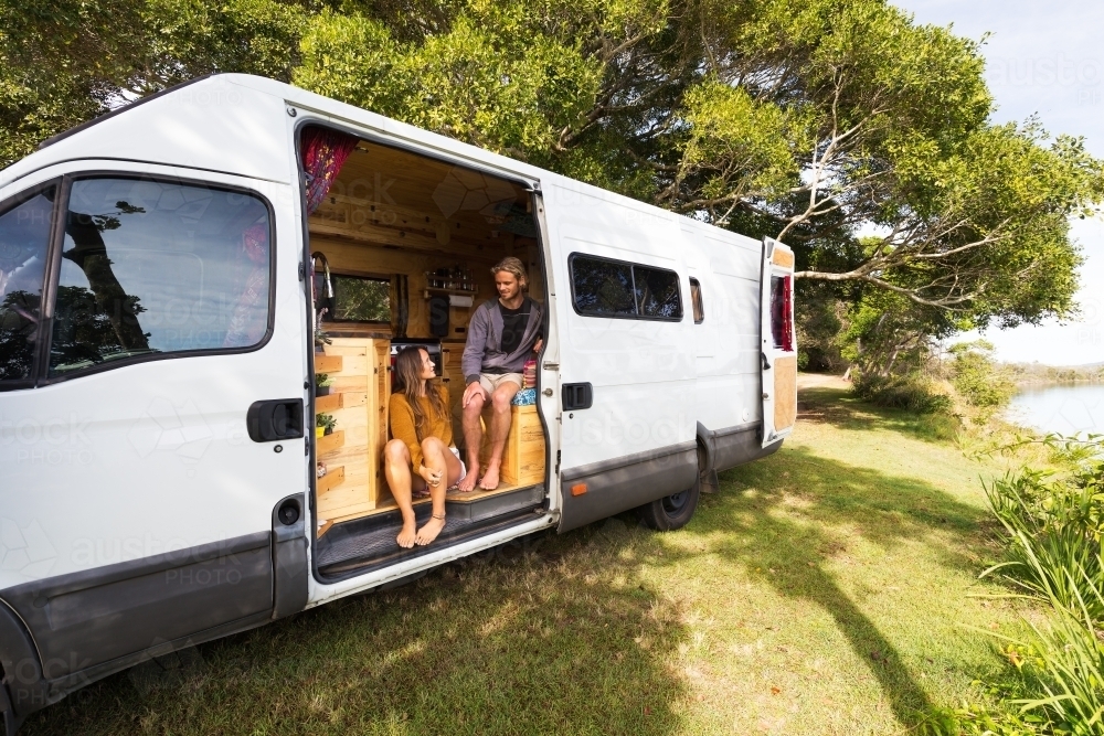 Van life couple in bohemian camper van at a scenic Australian location - Australian Stock Image