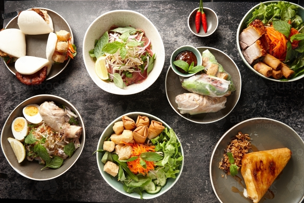Various Asian food dishes on table - Australian Stock Image