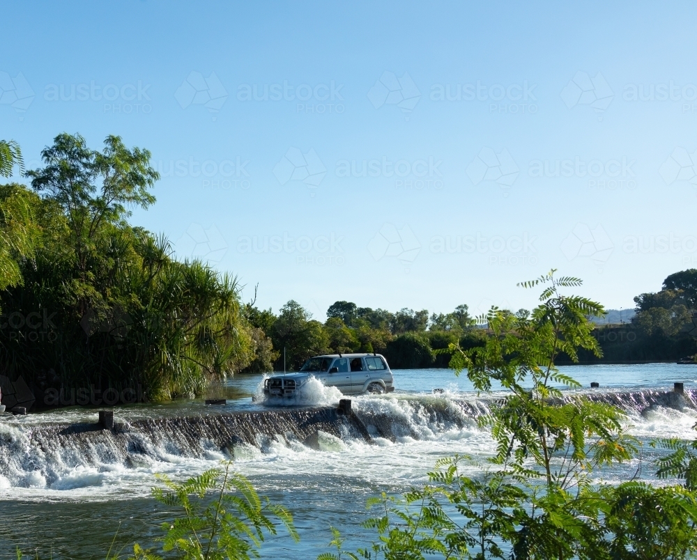 Image of vehicle crossing the flooded Ivanhoe crossing near Kununurra Austockphoto