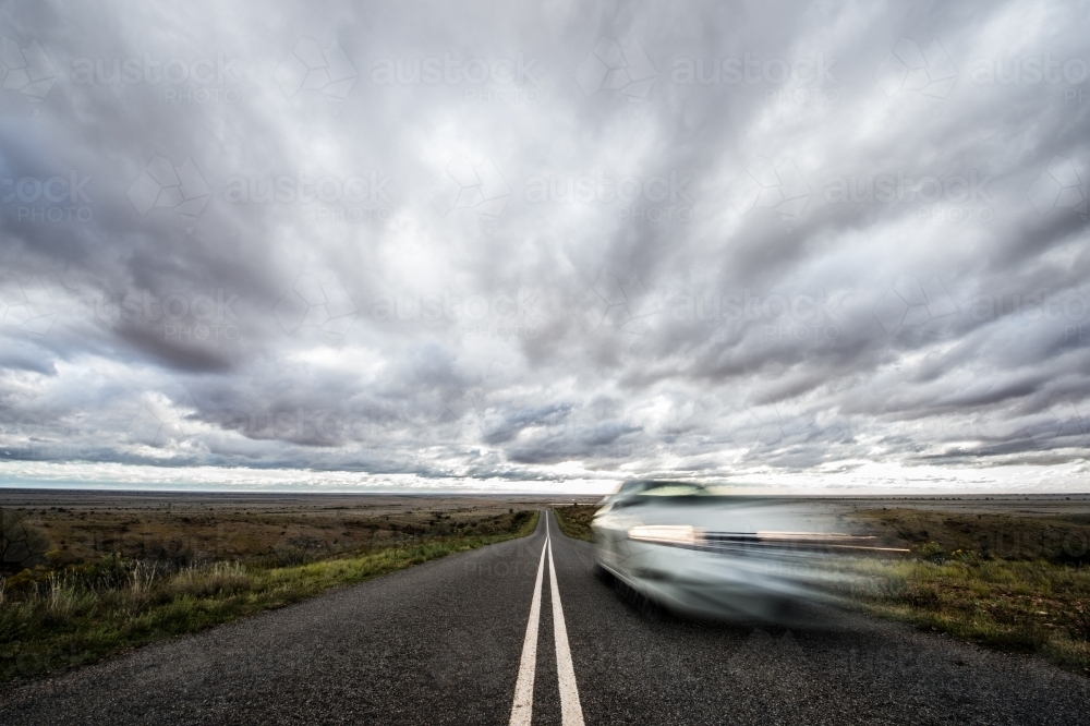 Vehicle in motion on remote road - Australian Stock Image
