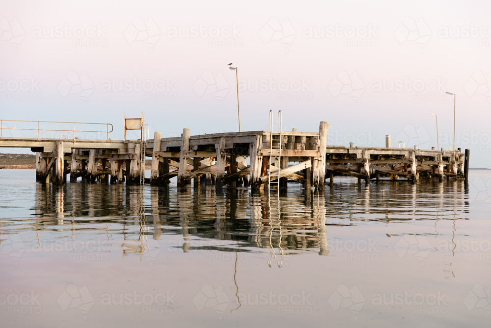 Venus Bay jetty reflecting on calm morning water : Austockphoto Venus Bay jetty reflecting on calm morning water - Australian Stock Image