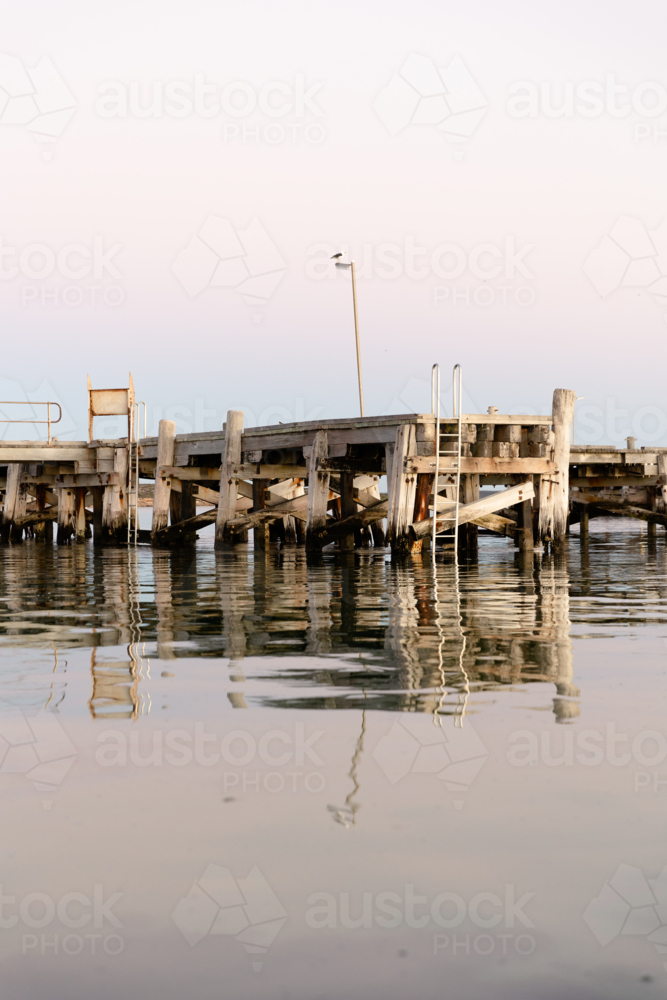 Venus Bay jetty reflecting on calm morning water : Austockphoto Venus Bay jetty reflecting on calm morning water - Australian Stock Image