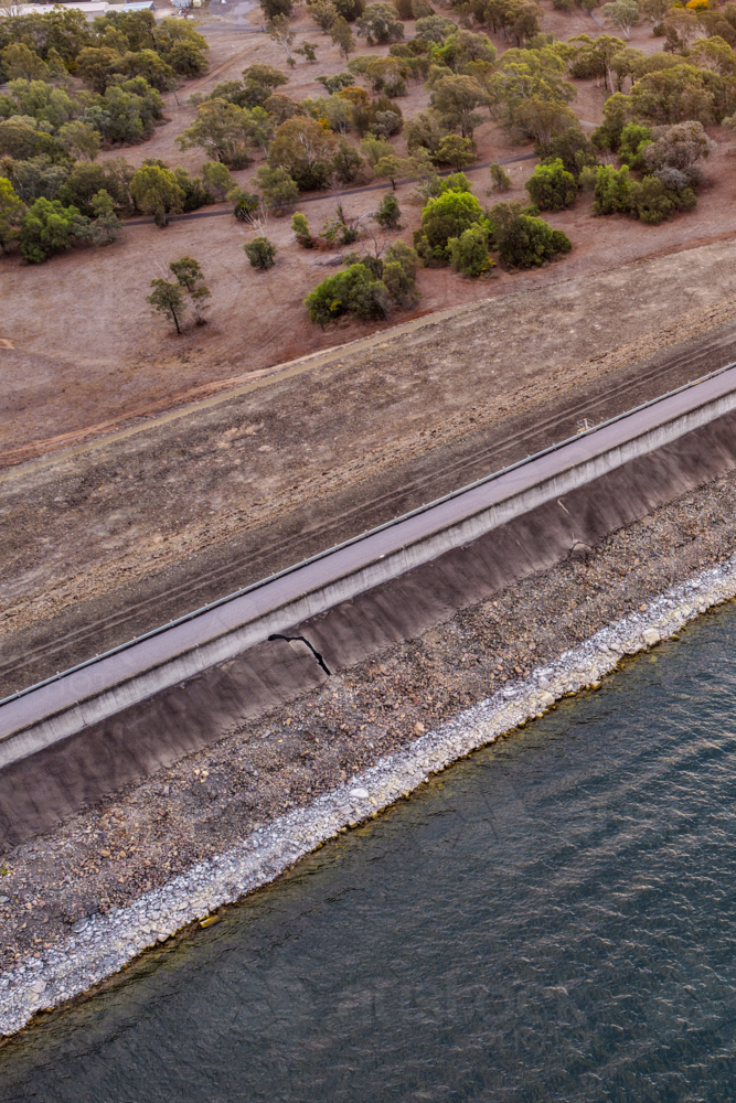 Vertical Aerial close up view of the Glenbawn Dam wall and surrounding landscape in NSW Australia. - Australian Stock Image