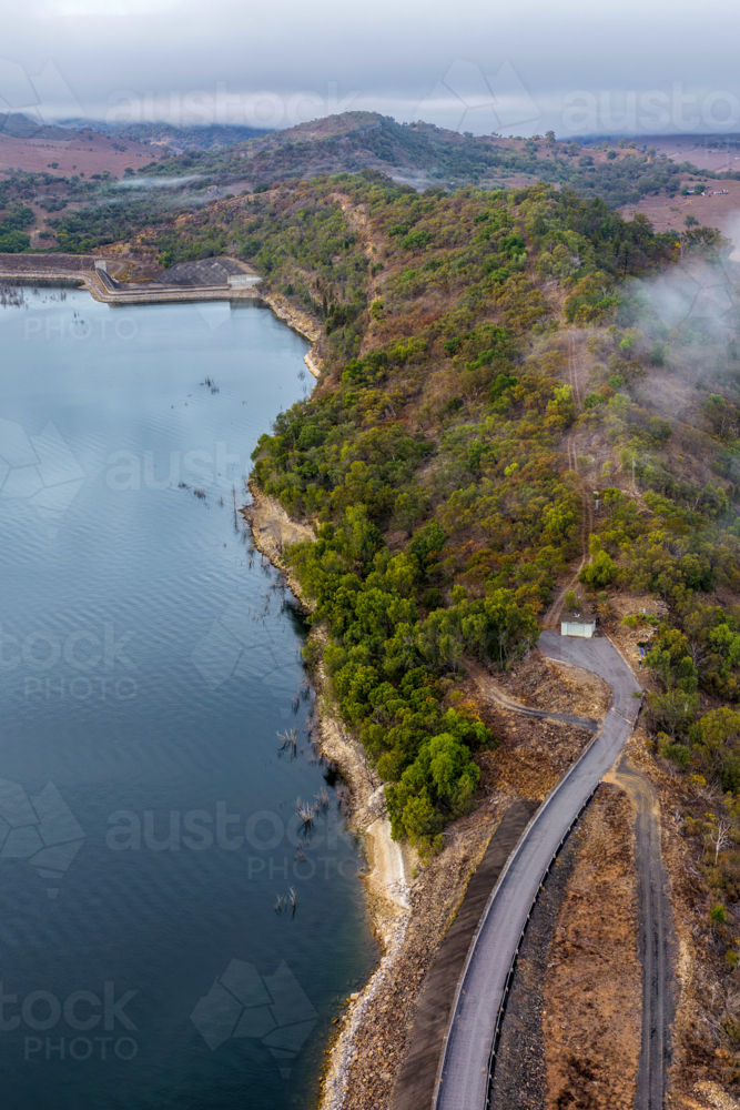 Vertical Aerial image of Glenbawn Dam and the surrounding mountain landscape with morning fog in NSW - Australian Stock Image