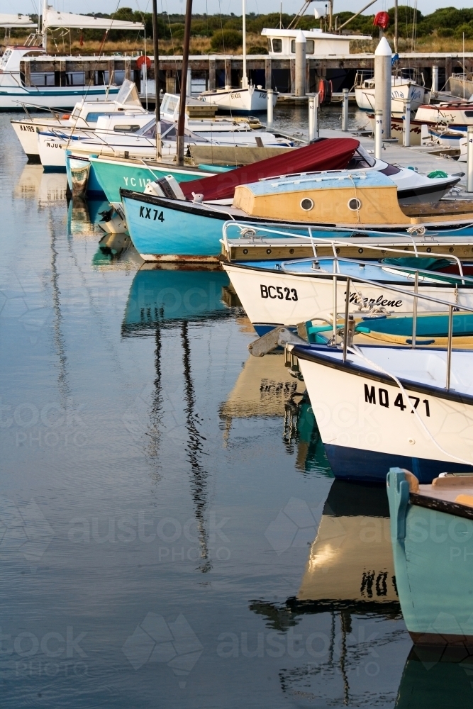 Vertical aspect of boats lined up at a harbour - Australian Stock Image