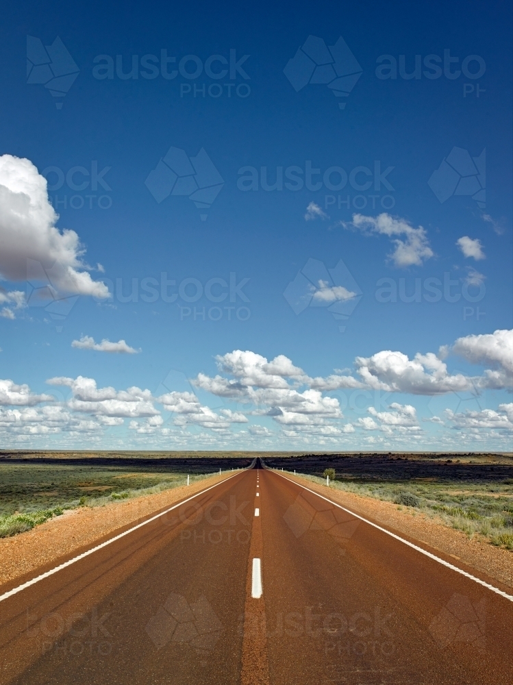 Vertical aspect of long straight Highway in outback - Australian Stock Image