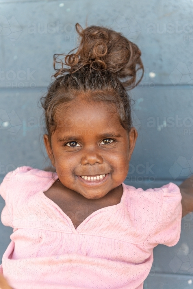 Vertical shot of 3 year old Aboriginal girl - Australian Stock Image