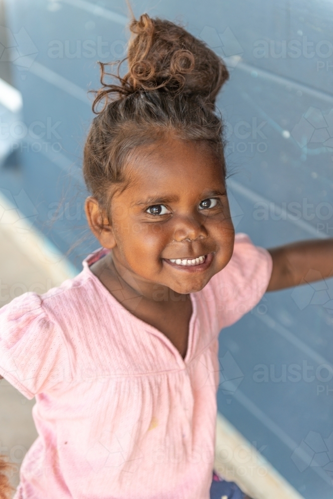Vertical shot of 3 year old Aboriginal girl - Australian Stock Image