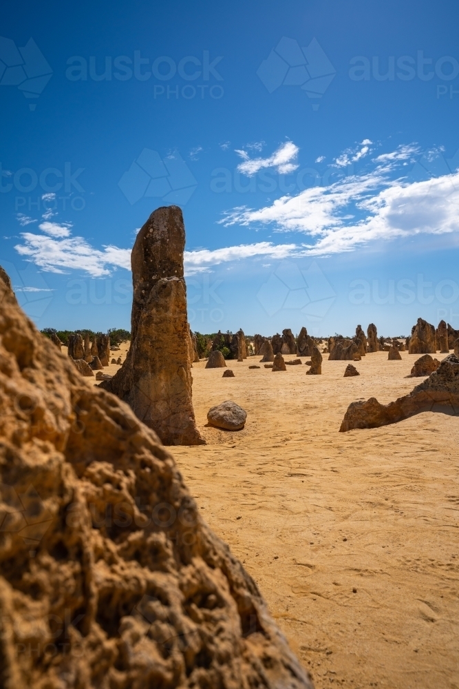 vertical shot of an outback with rocks on a sunny day with blue and white skies - Australian Stock Image