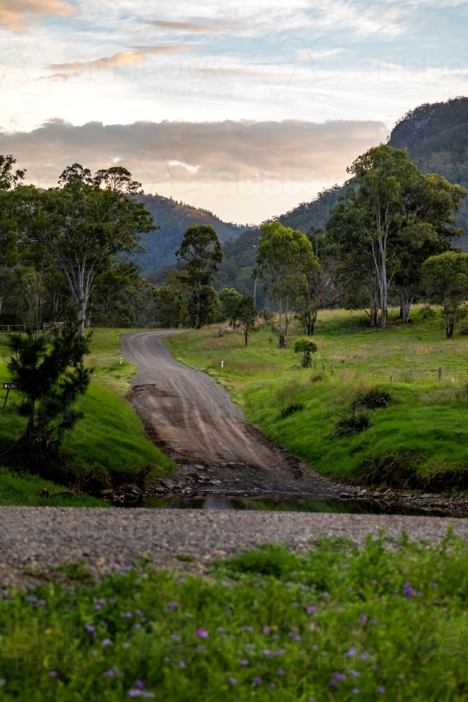 Vertical shot of low level creek crossing and mountain background - Australian Stock Image