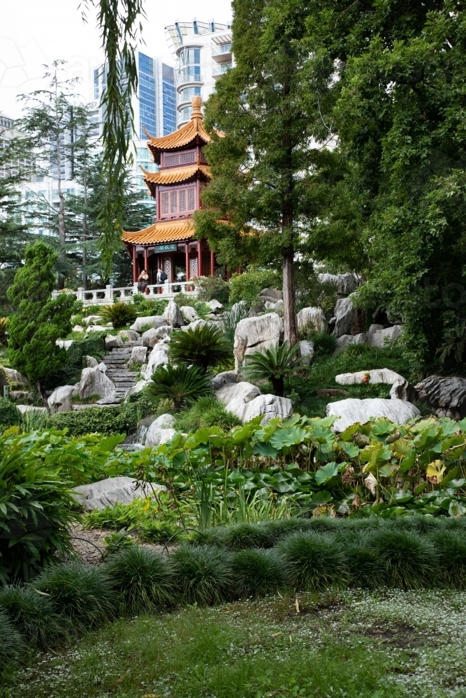 vertical view of terraced garden and pavilion with city in background - Australian Stock Image