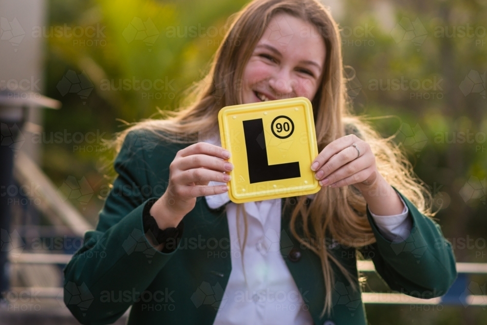 very happy teenager with her L-plate - Australian Stock Image