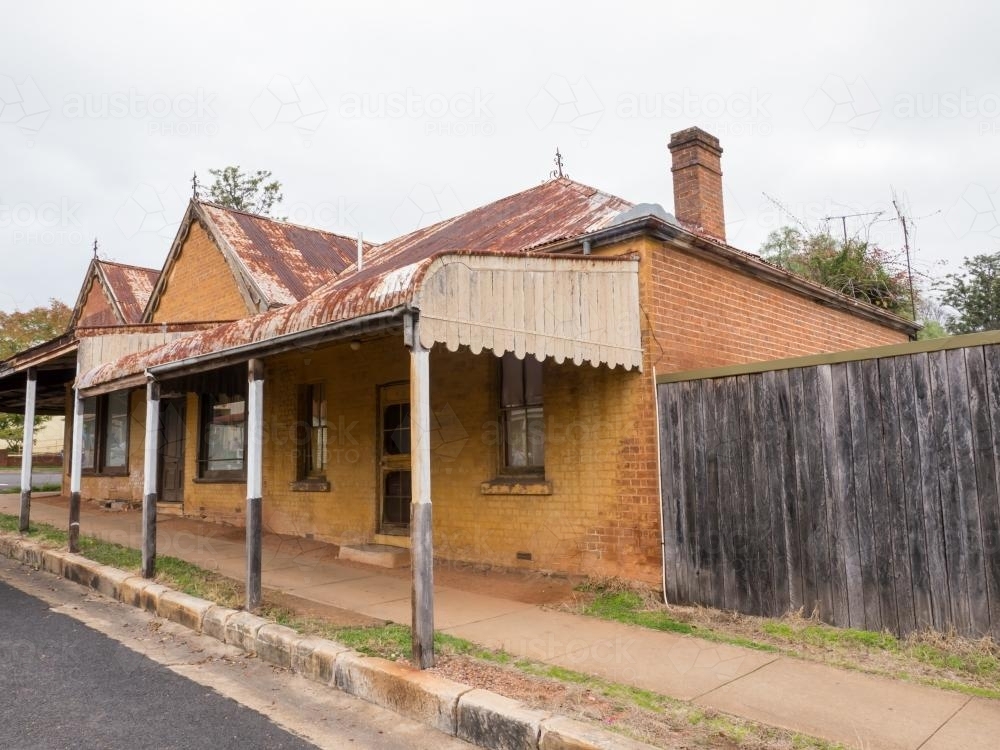 Very old building with awning and rusted roof on an overcast day - Australian Stock Image