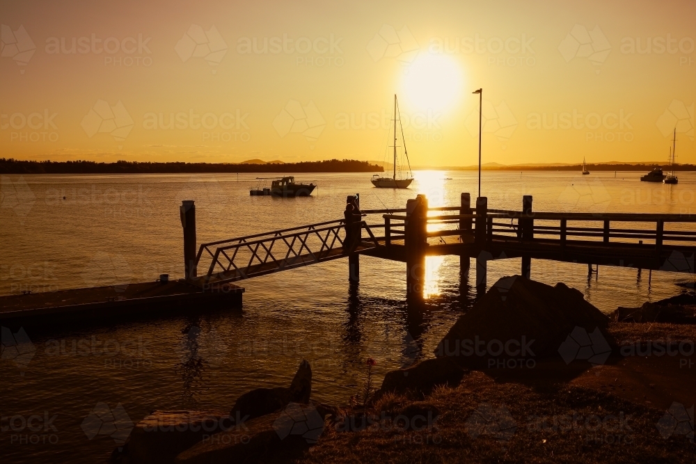 Vibrant afternoon sunset over jetty at Iluka in NSW Australia - Australian Stock Image
