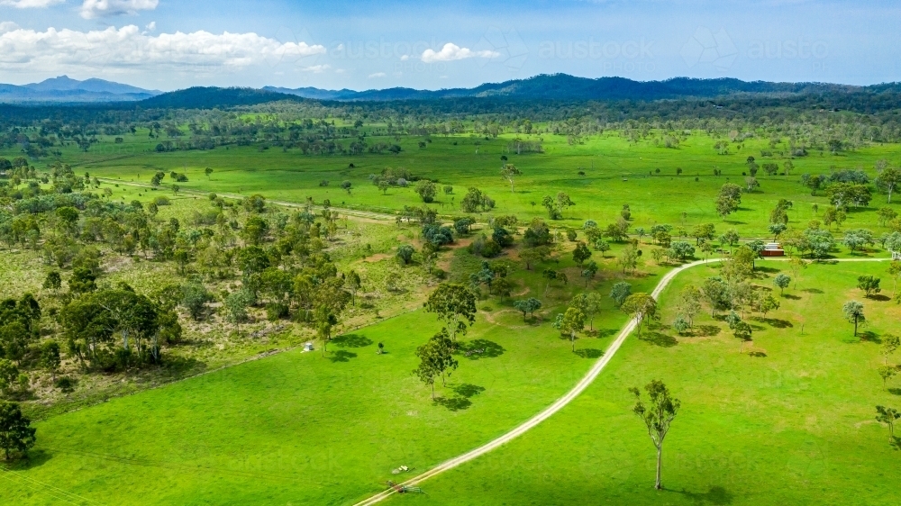 Vibrant green summer landscape showing a golf course and hills in the distance - Australian Stock Image