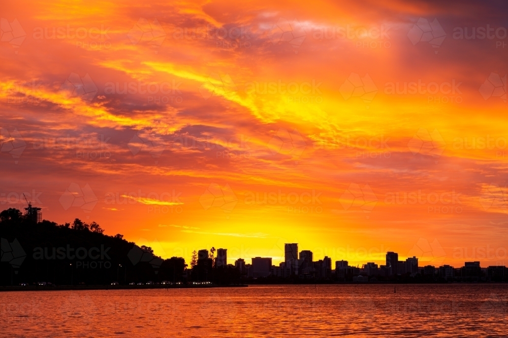 Vibrant orange sunset over South Perth and the Swan River. - Australian Stock Image