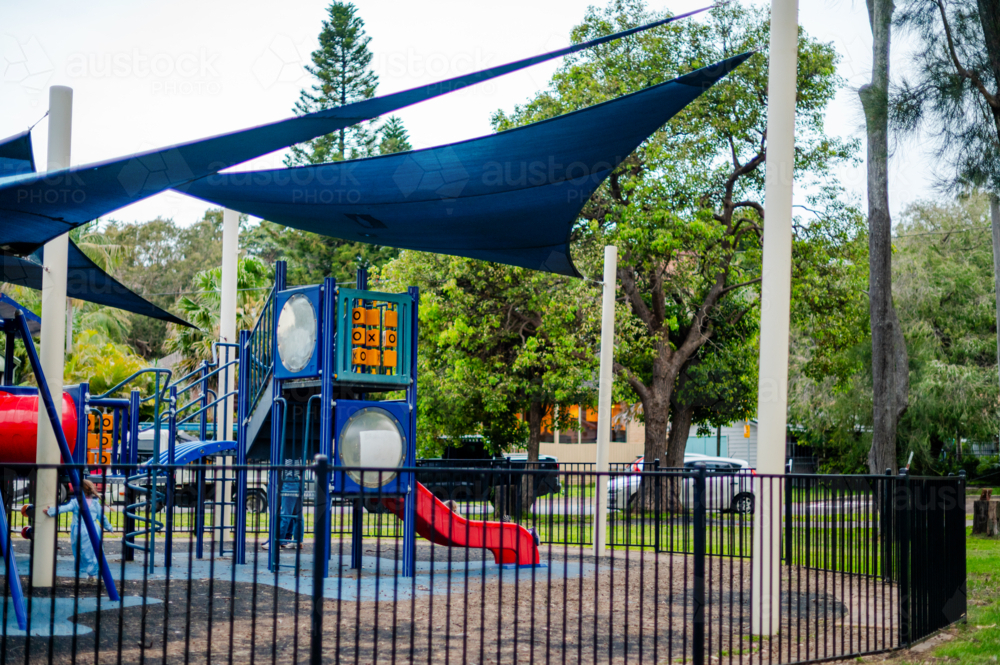 vibrant playground shaded by large sails in a park - Australian Stock Image