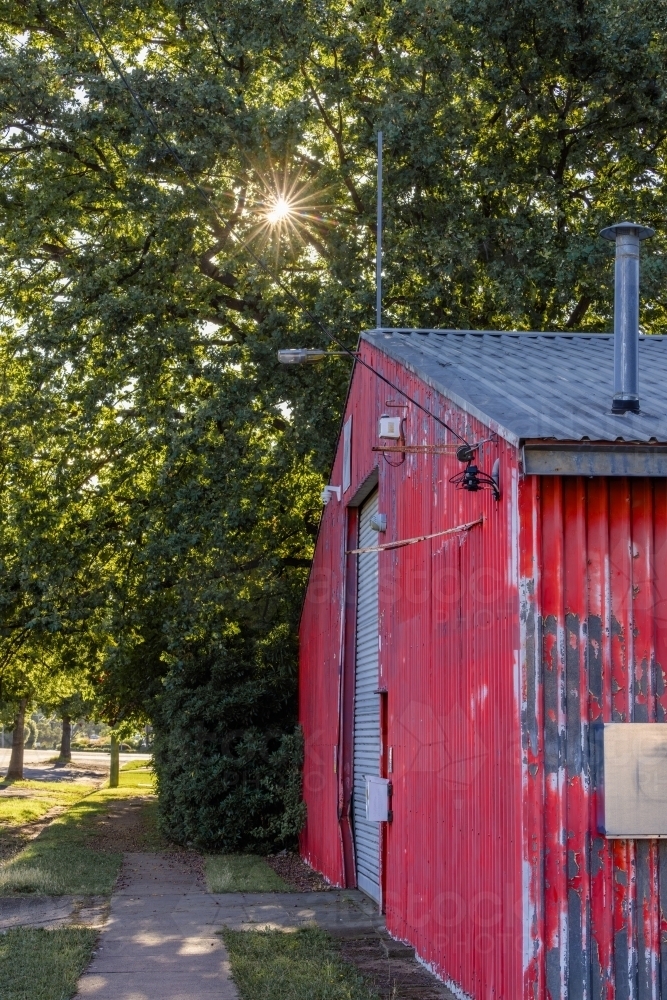 Vibrant red shed with large white door - Australian Stock Image