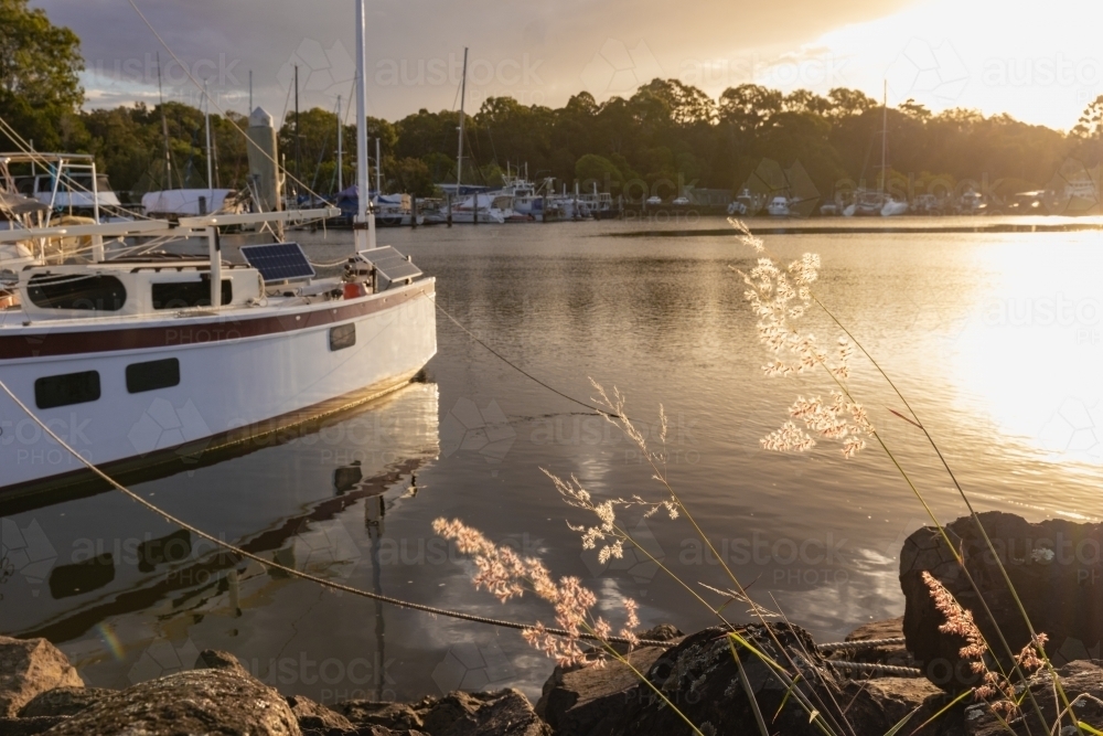 Vibrant sunset over boats moored at the Brunswick Heads marina - Australian Stock Image