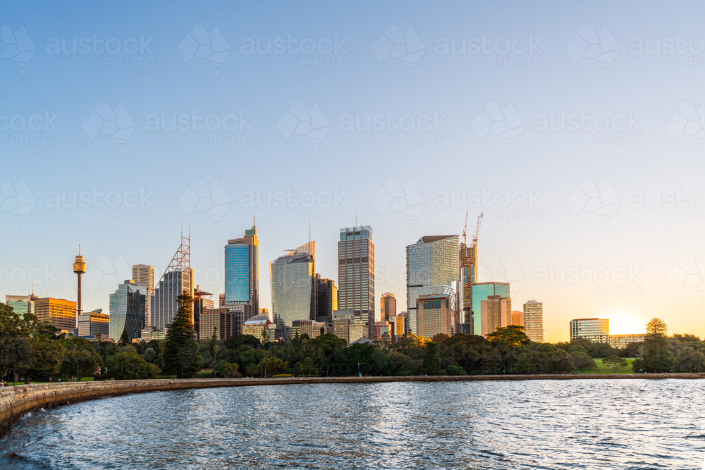 Vibrant Sydney City skyline embracing the golden hues of sunset - Australian Stock Image