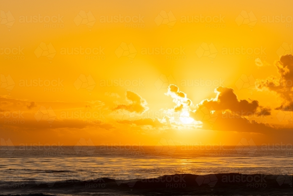 Image of Vibrant yellow sunrise over the ocean at Brunswick Heads, NSW ...