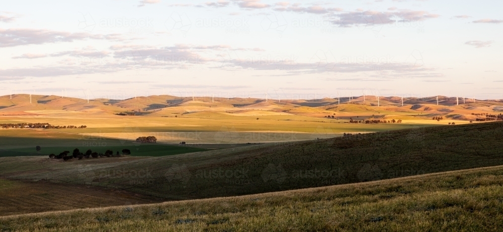 view across valley to wind turbines - Australian Stock Image