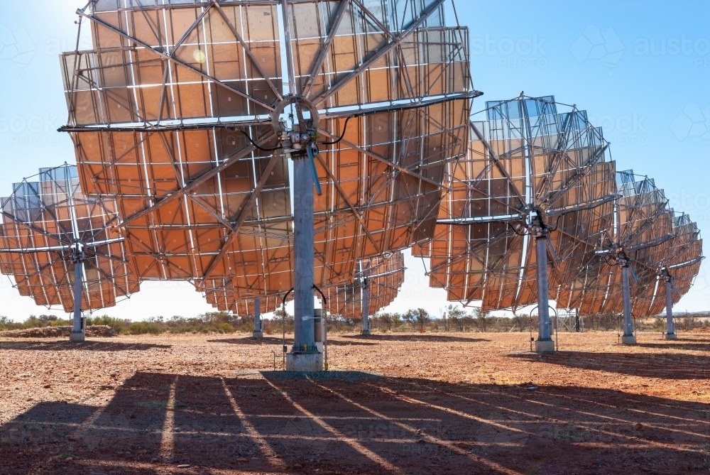 View behind set of solar panel dishes in regional Australia - Australian Stock Image