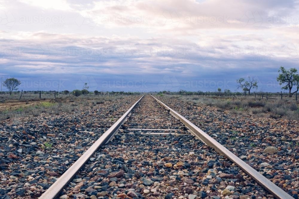 View down railway tracks into distance in remote location - Australian Stock Image