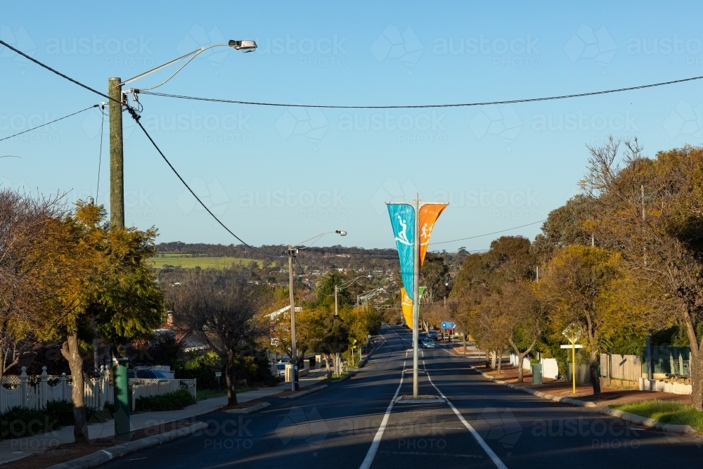 view down street in small country town with banners - Australian Stock Image