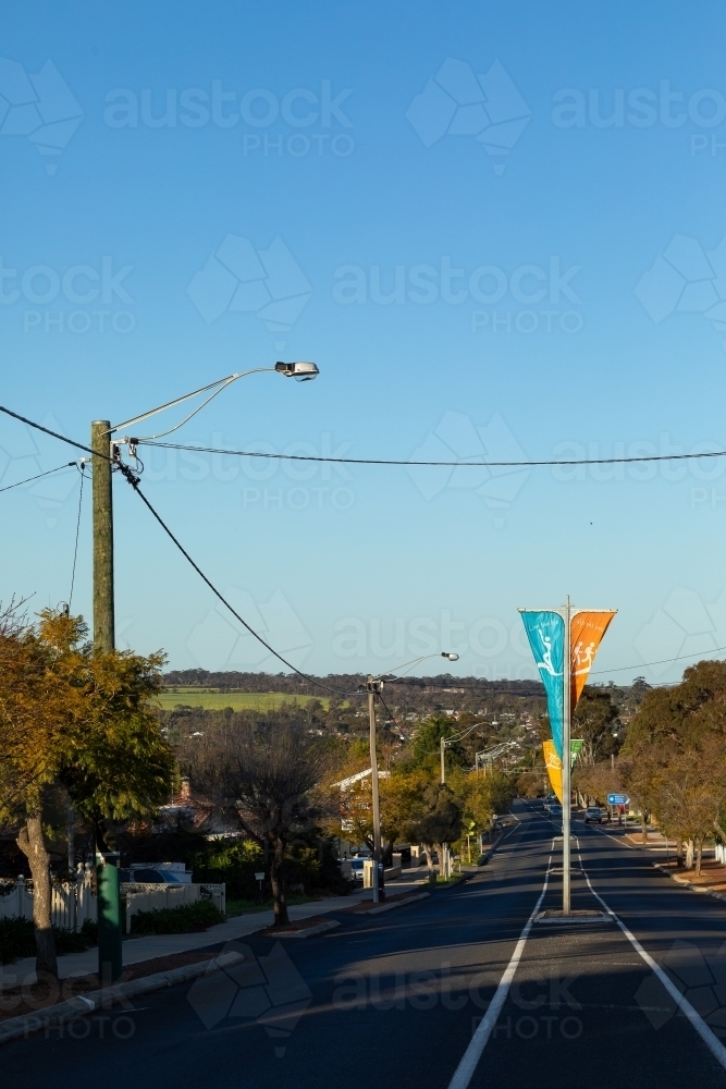 view down street in small country town with banners - Australian Stock Image