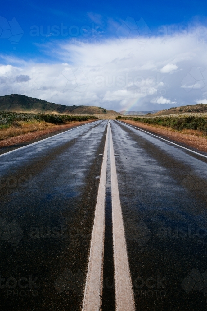 View down the double lines of a straight outback bitumen road - Australian Stock Image