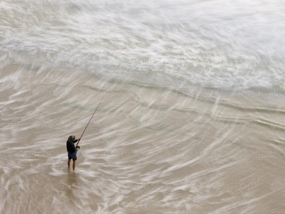 View from above of a Fisherman beach fishing - Australian Stock Image