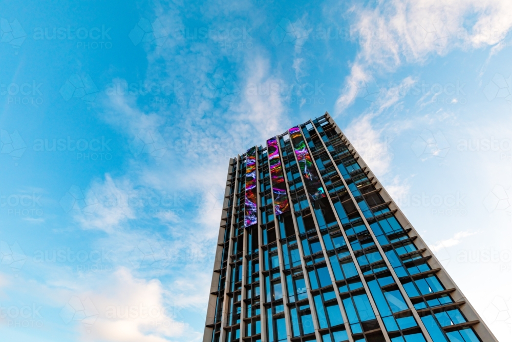 Image of View from below of tall building with digital screens with ...