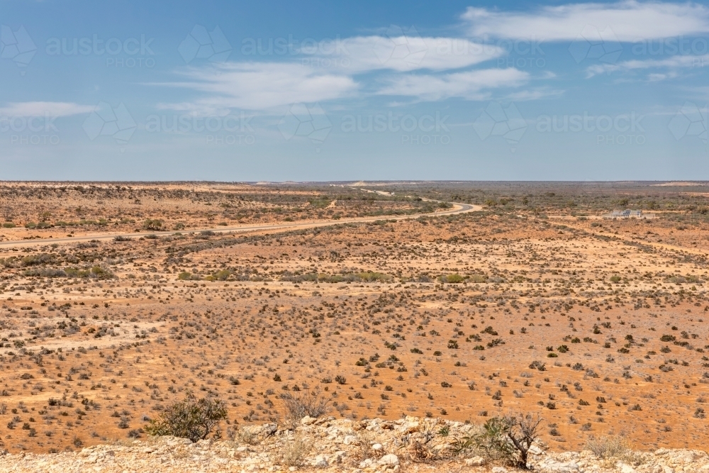 View from Gladstone Scenic Lookout showing road winding through flat,dry expanse - Australian Stock Image