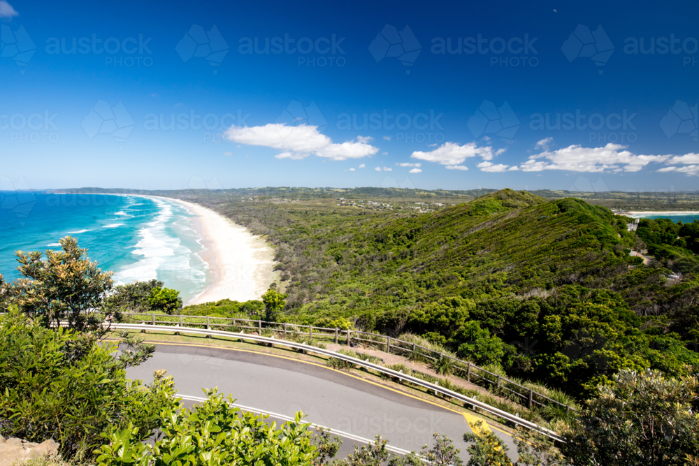 view from Lighthouse Rd over Tallows Beach and Cape Byron in Byron Bay, New South Wales - Australian Stock Image